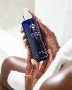 Youth Body Serum de la marca Is Clinical: Primer plano del producto en mano
